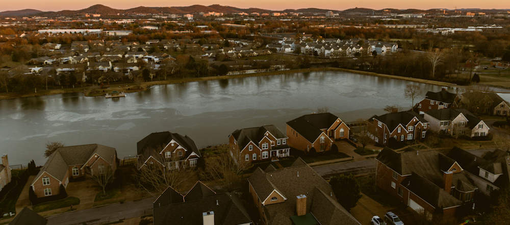 Aerial View Of Suburban Neighborhood And Lake At Sunset In Nashville by Josh Withers on Unsplash