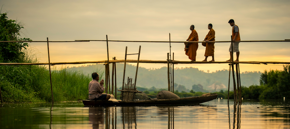 Monks on a Bridge in Thailand by Sippakorn Yamkasikorn on Unsplash