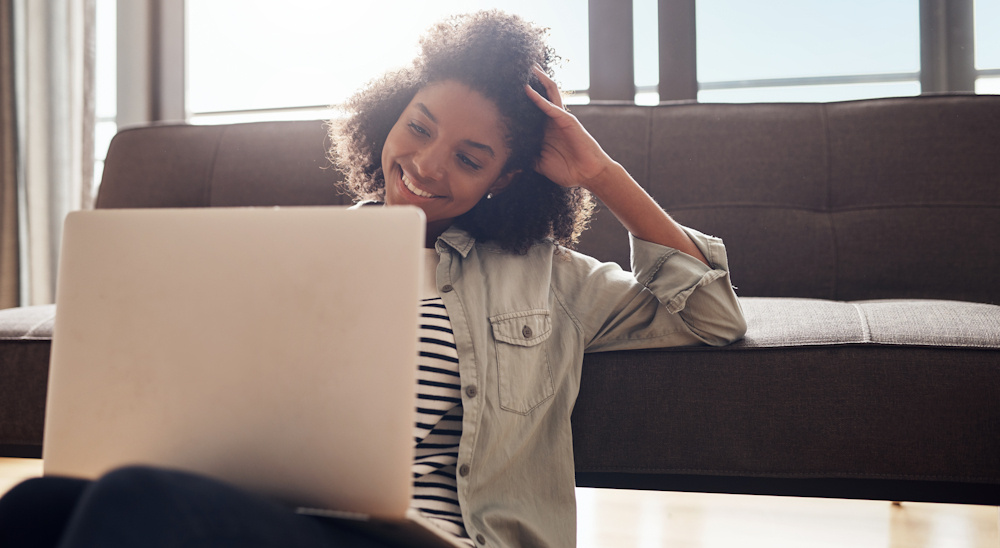 Woman using a laptop and smiling