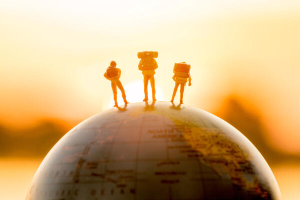 Figurines on top of a globe